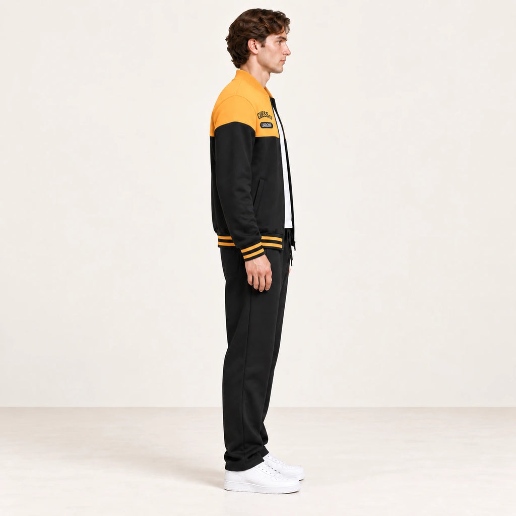 Ensemble de survêtement esprit baseball jaune et noir, porté de profil en studio ivoire