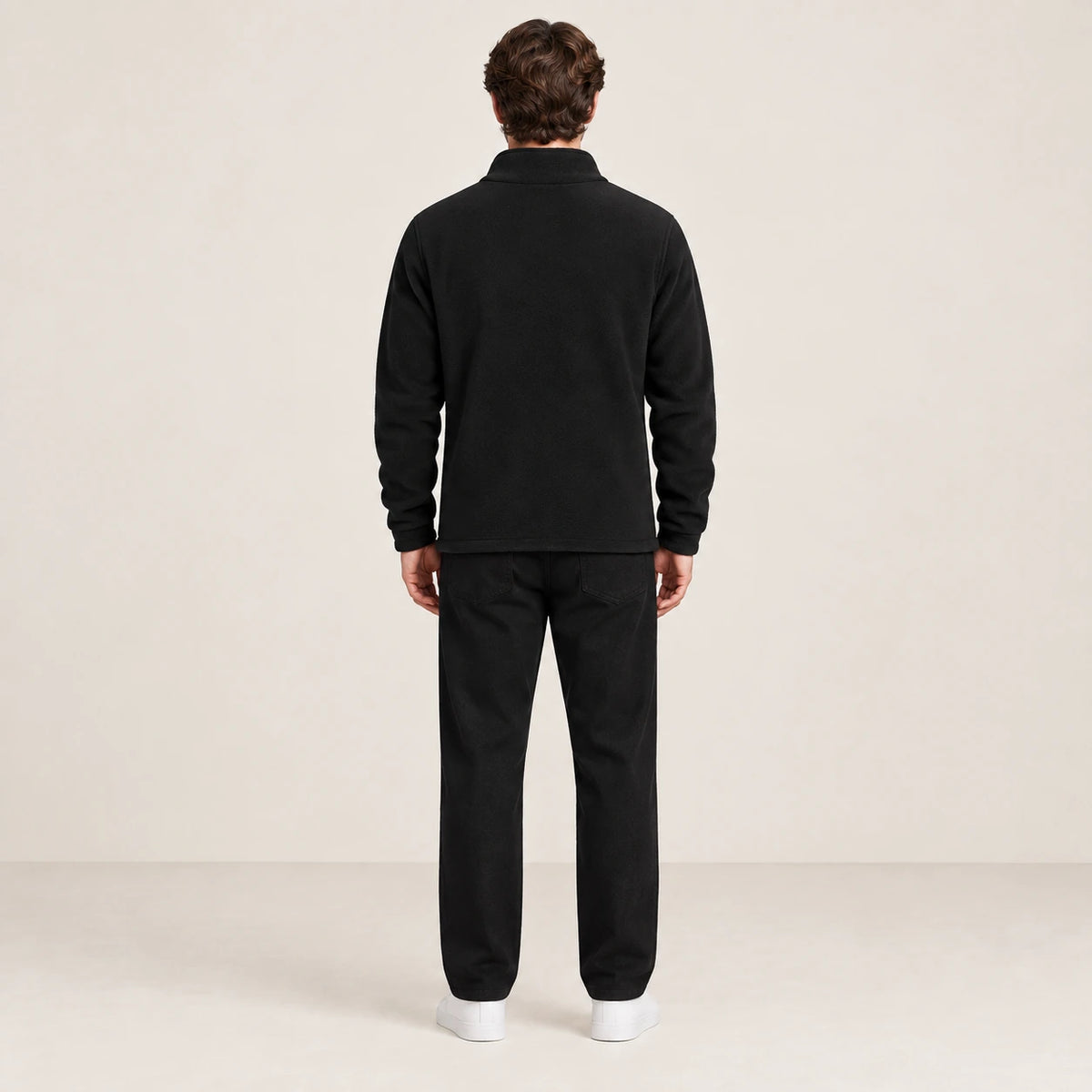 Gilet polaire noir à col montant doublé, vu de dos dans le studio IVAREE.