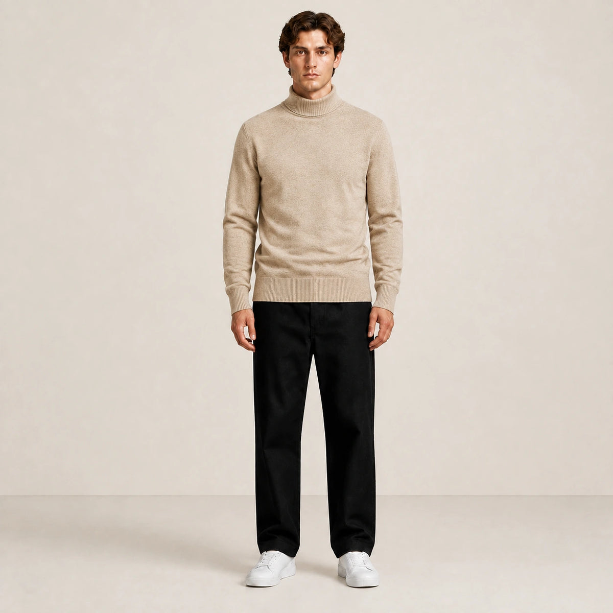 Pull col roulé beige en maille fine, porté de face dans le studio IVAREE.