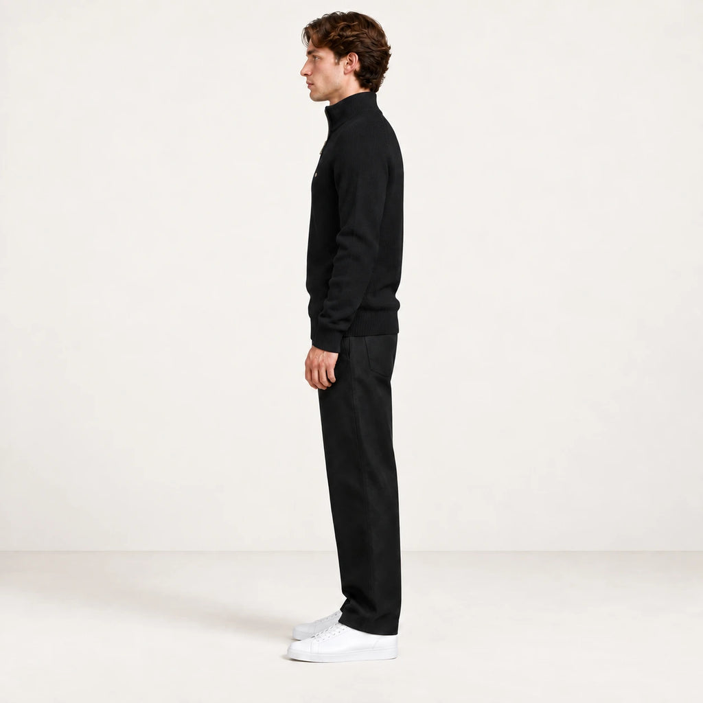 Pull demi-zip noir en maille côtelée, vue de profil dans le studio IVAREE