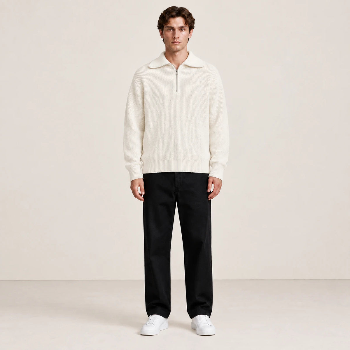 Pull blanc à col zippé porté de face dans le studio IVAREE.