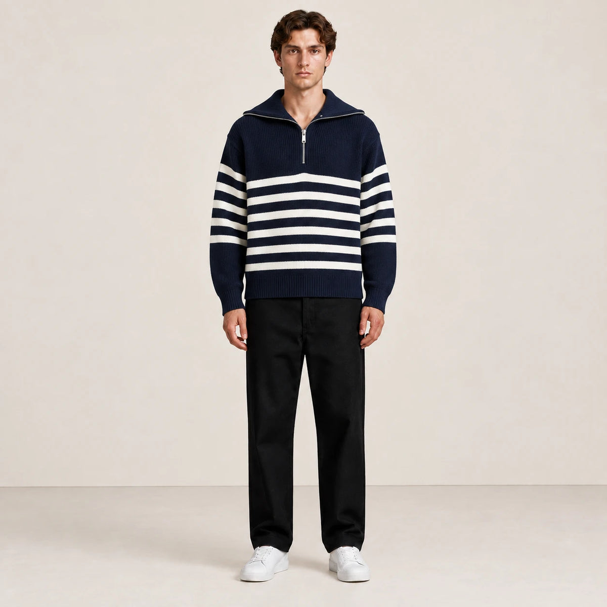Pull bleu marine à col zippé porté de face dans le studio IVAREE.
