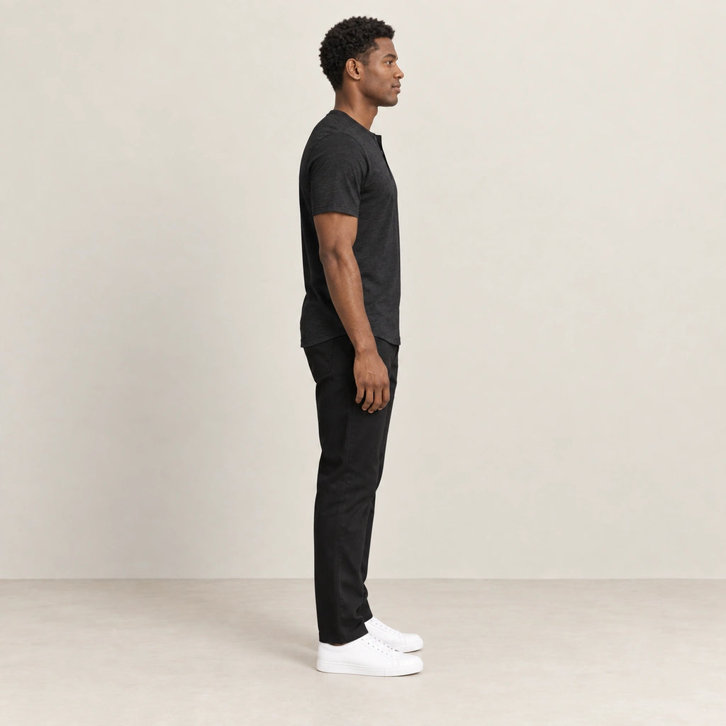 T-shirt noir à col Henley boutonné, vue de profil dans le studio IVAREE.