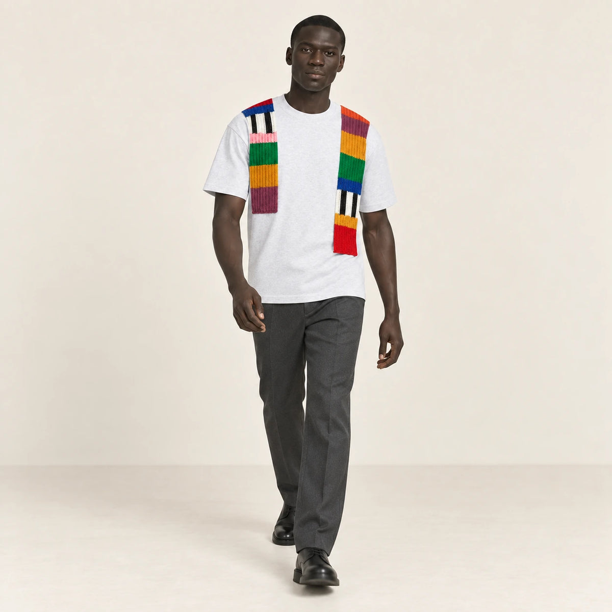 T-shirt gris clair à bandes de maille multicolores, porté en mouvement dans le studio IVAREE.