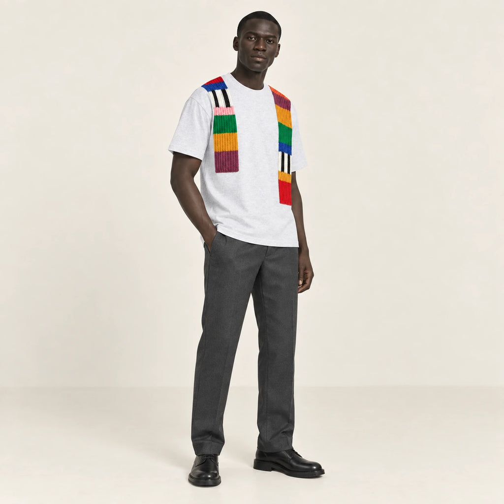 T-shirt gris clair à bandes de maille multicolores, porté de trois-quarts dans le studio IVAREE.