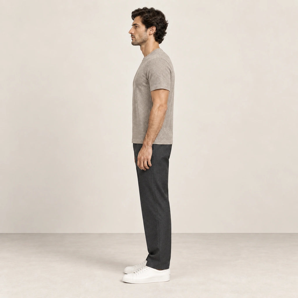 T-shirt kaki clair en maille jacquard à fines lignes verticales, porté de profil dans le studio IVAREE.